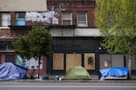 Tents line a street in front of boarded up shops on April 15, 2020, in downtown Portland. As businesses have closed and resources have moved online or over the phone, mental health treatment has also become more difficult to access for many in the unhoused community.