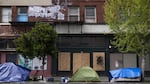 Tents line a street in front of boarded up shops on April 15, 2020, in downtown Portland. As businesses have closed and resources have moved online or over the phone, mental health treatment has also become more difficult to access for many in the unhoused community.