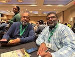 Finis Stribling III (left) and John Green II (right) take a break during the National Black Growers Council conference in New Orleans on Dec. 10, 2025. Both Stribling and Green were plagued by bad weather at the start of this year's growing season, and both said tariffs have only made things harder.