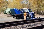 Investigators clear wreckage from a vehicle-train collision off the side of the tracks near Kelso, Washington.