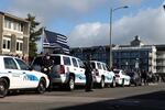 Officers stand guard as Sgt. Jason Goodding’s casket is carried into the Seaside Convention Center.