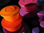 Colorful Tupperware products are displayed at a selling party in California.