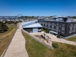 A blue whale skeleton is seen in the courtyard of the Gladys Valley Marine Studies Building at Hatfield Marine Science Center in Newport, with the Yaquina Bay Bridge in the background.