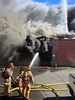 Firefighters spray water onto a fire at Shin Shin Foods in Portland, Ore., Monday, June 24, 2024. Portland Fire & Rescue responded to three separate commercial fires in the afternoon and evening hours Monday.