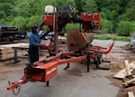 Thursday, May 21, 2026 — Saul Esparza uses a portable bandsaw mill at Camp Small, a wood waste collection yard run by the Baltimore City Department of Recreation and Parks, in Baltimore, MD.