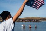 Protesters wade in the Cannon Ball River during a standoff with the police at Turtle Island north of the Standing Rock Reservation in North Dakota, on Nov. 2, 2016.