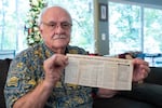 Henry Groepper poses for a portrait with a preserved newspaper clipping at his home in Portland, Ore., on Sept. 18, 2026. The article details dozens of felony cases that Crime Stoppers of Oregon helped to solve in 1987.