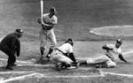 FILE - Brooklyn Dodgers' Jackie Robinson safely steals home plate under the tag of New York Yankees catcher Yogi Berra as pinch-hitter Frank Kellert looks on in the eighth inning of the World Series opener at New York's Yankee Stadium, Sept. 28, 1955.