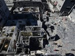 Palestinians inspect the rubble of destroyed buildings after an Israeli airstrike at the Nusseirat refugee camp, in central Gaza on Thursday.