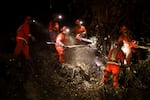 A California Department of Corrections hand crew works containment lines ahead of the Palisades Fire Tuesday, Jan. 14, 2025 in Santa Monica, Calif.