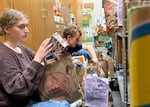 Packed with Pride volunteers Lena Hale and Ben Wornath sort through donated groceries the pantry received, Nov. 6, 2025.