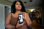 Sima Gutierrez shows a photo of herself with her mother, during an interview, Monday, March 25, 2024, in Flint, Mich. It was a decade ago that she complained her stomach hurt when she drank water.