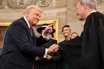 President Donald Trump gestures to Supreme Court Chief Justice John Roberts after being sworn in as president during the 60th Presidential Inauguration in the Rotunda of the U.S. Capitol in Washington, Monday, Jan. 20, 2025.