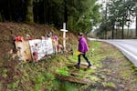 Rebecca Zuber takes flowers to her daughter’s roadside memorial on the anniversary of her daughter Sarah’s death, in Rainier, Ore., March 13, 2025. Sarah Zuber, 18, was found dead 400-feet from her front door.