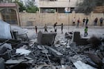 Palestinians inspect the site of an early morning Israeli airstrike in Gaza city, Saturday, Oct. 3, 2026.