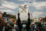 A protester holds a placard during a demonstration against repeated water and electricity outages in Madagascar.