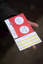 Former Portland Public Schools Chinese language specialist Yvonne Liao shows her old PPS translation and interpretation business cards with different phone numbers for each language service offered in Portland, Ore., on Dec. 2, 2025.