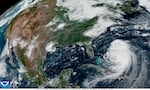 A satellite image captured late Tuesday morning, ET, shows Hurricane Erin moving to the northwest over the Atlantic Ocean. Forecasters predict the large storm will follow a path curving toward and then away from the U.S. East Coast in the coming days.