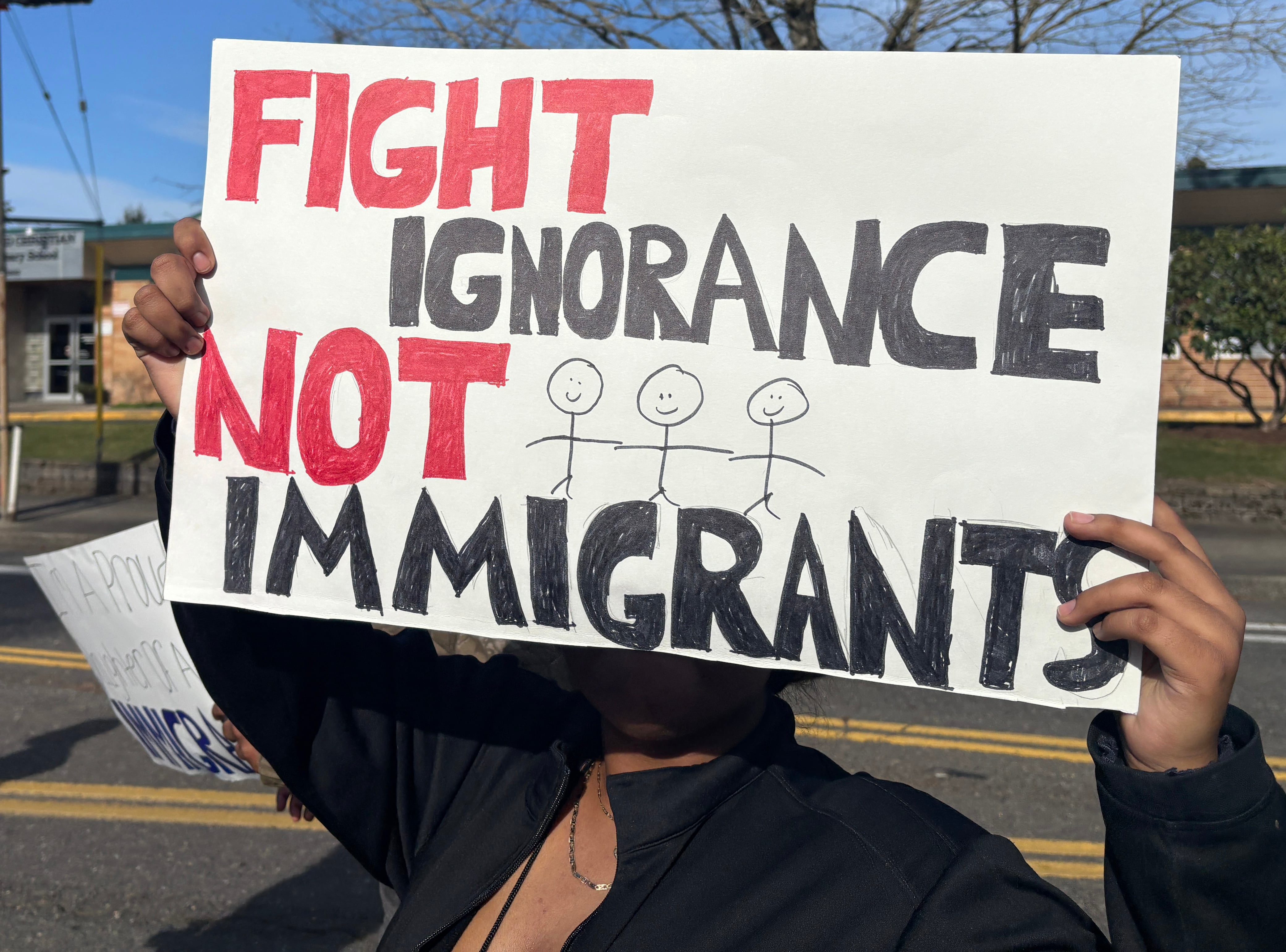 David Douglas High School students walked out of class Friday, Feb. 6, 2026, to protest actions by immigration and customs enforcement. Students carried signs and chanted as they walked, flanked by adults in safety vests.