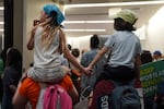 Palikulani Soileau, 7, left, holds hands with her classmate Eliza Janowitch, 7, both second graders at Maplewood Elementary School in Portland, Ore., as they attend a Portland Public Schools board meeting.