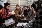 Palestinian children, who took shelter with their families in a school to protect themselves from Israeli attacks, continue their Quran education in Rafah on Jan. 20.