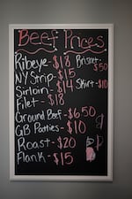 A chalkboard with handwritten beef prices is seen at Hallstead Farms. Prices range from $50 for brisket to $6.50 for ground beef.