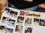 Smith shows a poster board with photos of Goods during his childhood.