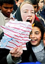 American activist Rachel Corrie, 23, shouts during an anti-war, pro-Iraq rally by Palestinians and foreign activists in February 2003 in the Rafah refugee camp in the Gaza Strip.