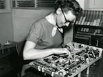 Woman assembling scope, ca 1950s