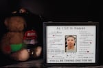 A framed photo of Christian sits on a shelf in Bobbie and DeForrest's home. A poem titled "As I Sit In Heaven" surrounds the photo.