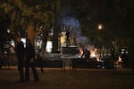 A protester stands where an elk statue used to stand during protests against racism and police violence on July 14, 2020. 