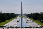 Workers refill the Lincoln Memorial Reflecting Pool on Friday, after weeks of resurfacing.