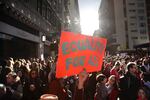 Kelly Crowder (center) holds up a sign as thousands of protesters gather for the Women's March against President Donald Trump Jan. 21, 2017, in Los Angeles.