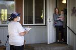 A member of OSU's field team surveys a household for a pilot run of their study. Data taken this day will not be included in the final study, which starts next week.