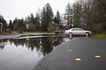 A car sits surrounded by saltwater at the boat ramp in Nehalem, Oregon. When king tides meet heavy rain, the parking lot can fill with over a foot of water.