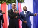 Edgard Leblanc Fils, left, and Smith Augustin prepare to pose for a group photo with the transitional council after it named Fils as its president in Port-au-Prince, Haiti, Tuesday, April 30, 2024.