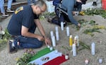 People at the vigil lit candles in honor of Lorenzo Salgado Araujo, and placed bouquets across the plaza.