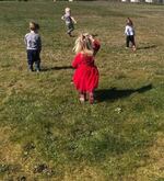 Children walk across a field near their child care center, Wonders Early Learning Center, before it closed in March 2020, amid the coronavirus pandemic.