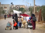Displaced Palestinians in Rafah in the southern Gaza Strip carry their belongings as they leave following an evacuation order by the Israeli military on May 6.