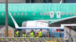 Workers are pictured next to an unpainted 737 aircraft and unattached wing with the Ryanair logo as Boeing's 737 factory teams held a "Quality Stand Down" for the 737 program at Boeing's factory in Renton, Wash. on January 25, 2024.