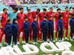 The team of Iran standing on the pitch waiting for the national anthem prior to the the match against England on Nov. 21. The team stayed silent during the anthem in apparent solidarity with protesters.