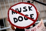 A demonstrator holds a sign during a February rally in Los Angeles to protest President Trump’s billionaire adviser Elon Musk and his DOGE team.