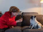 In a scene from the German TV series Miss Merkel, actress Katharina Thalbach, playing the amateur detective based on the former German Chancellor Angela Merkel, takes a closer look at her pug Helmut.