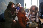 A woman and her three children sit in their Ukraine apartment, speaking to media about the war with Russia.