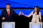 Former UN Ambassador Nikki Haley, right and Florida Gov. Ron DeSantis, left, pointing at each other during the CNN Republican presidential debate at Drake University in Des Moines, Iowa, Jan. 10, 2024.