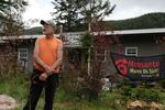 Harry Hoffman stands outside his house on Oregon Route 38.