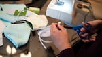 Aurora Oliva Ma of Beaverton, Ore., sews DIY protective face masks using materials purchased from JoAnn Fabrics at her home on March 19, 2020. Oregon Health & Science University officials say, for now, they are researching effective materials and sewing patterns people could use to sew masks for them.