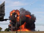 A historic military plane crashes after colliding with another plane during an airshow at Dallas Executive Airport in Dallas on Saturday.