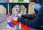 A student puts finishing touches on her final project for Darshanpreet Gill’s class at McDaniel High School, a colorful, detailed illustration of the human body.