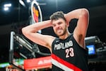 Portland Trail Blazers center Donovan Clingan (23) reacts after being fouled during the second half of an NBA basketball game against the Detroit Pistons, Monday, Dec. 22, 2025, in Portland, Ore.